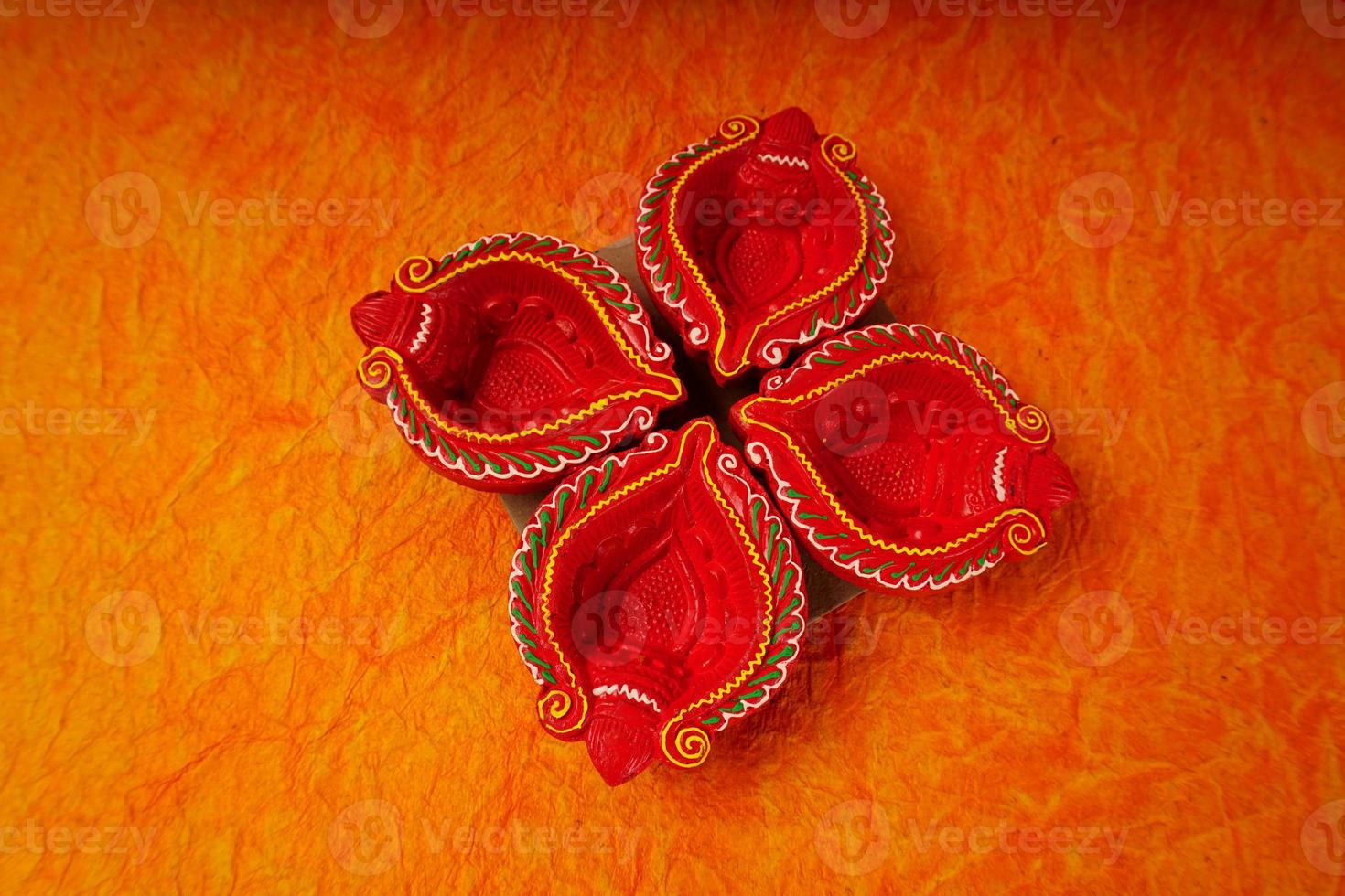 Happy Diwali - Diya lamps lit during Diwali celebration. Colourful and decorated lantern are lit in night on this occassion with flower rangoli, sweets and gifts. photo