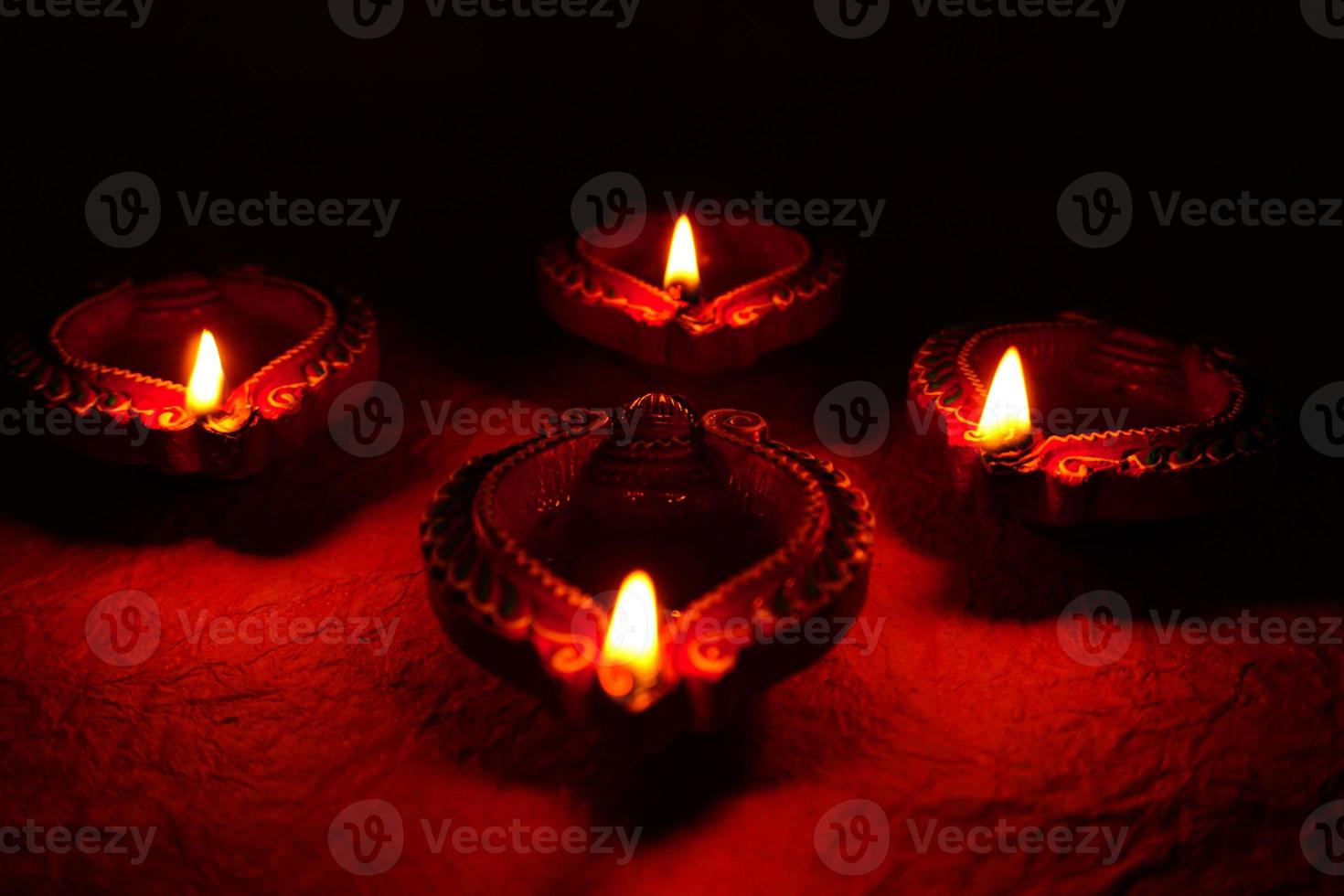 Happy Diwali - Diya lamps lit during Diwali celebration. Colourful and decorated lantern are lit in night on this occassion with flower rangoli, sweets and gifts. photo