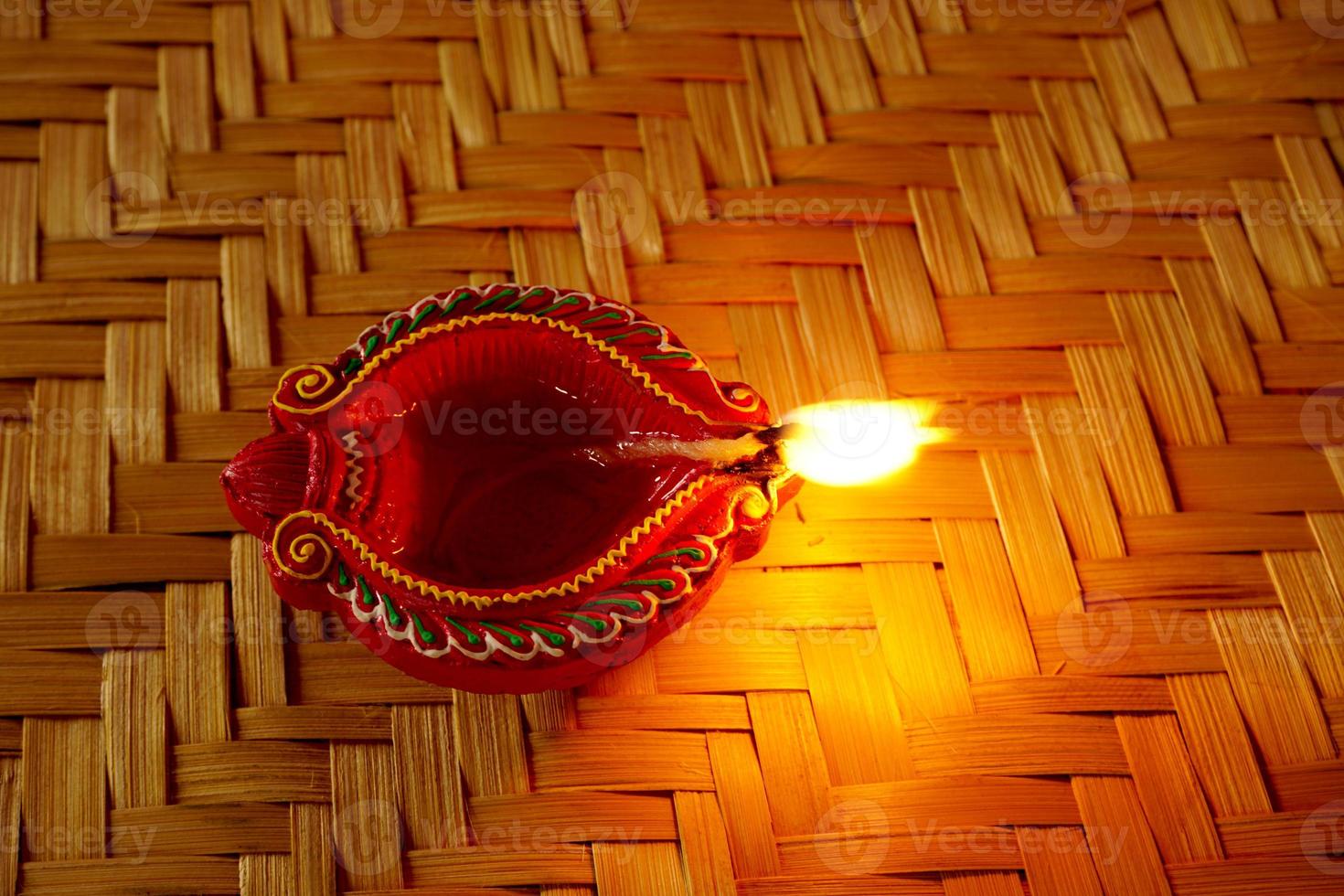 Happy Diwali - Diya lamps lit during Diwali celebration. Colourful and decorated lantern are lit in night on this occassion with flower rangoli, sweets and gifts. photo