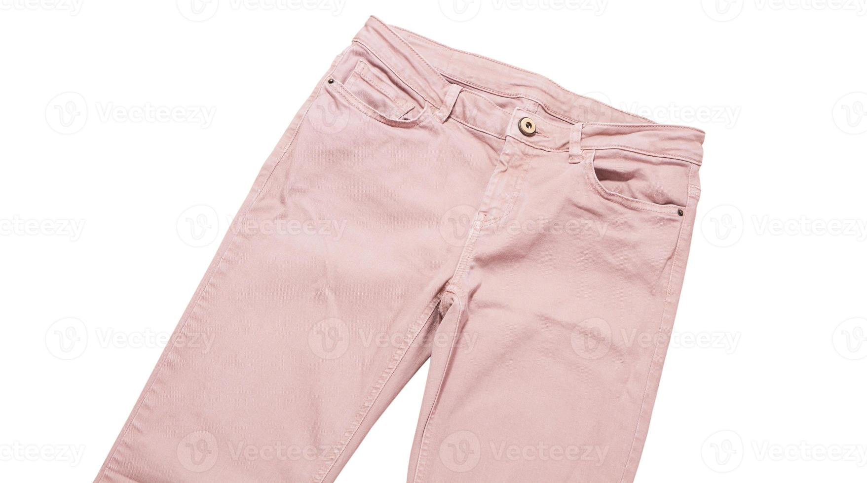 Female pants, light pink denim pants top view isolated on white background, folded slim pants photo