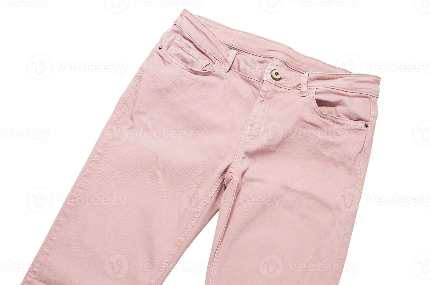 Female pants, light pink denim pants top view isolated on white background, folded slim pants photo