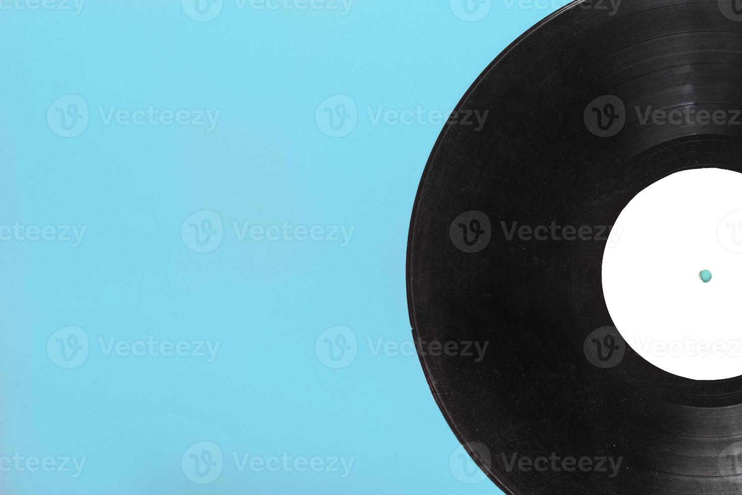 single circular vinyl record blue background photo