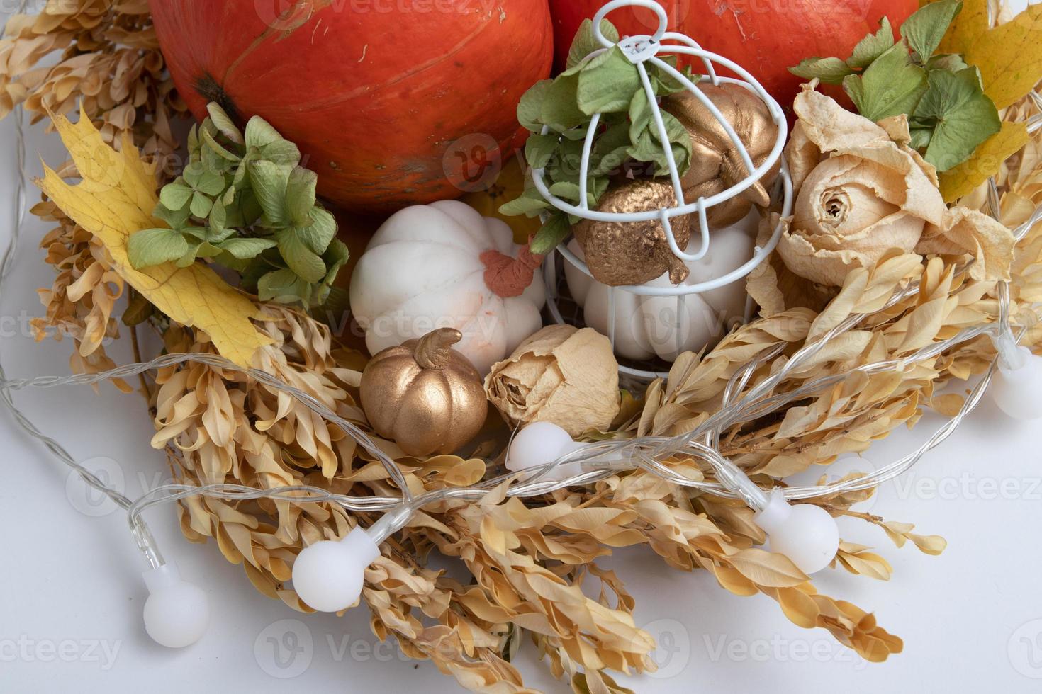 Autumn still life of pumpkins, dried flowers with a candle photo