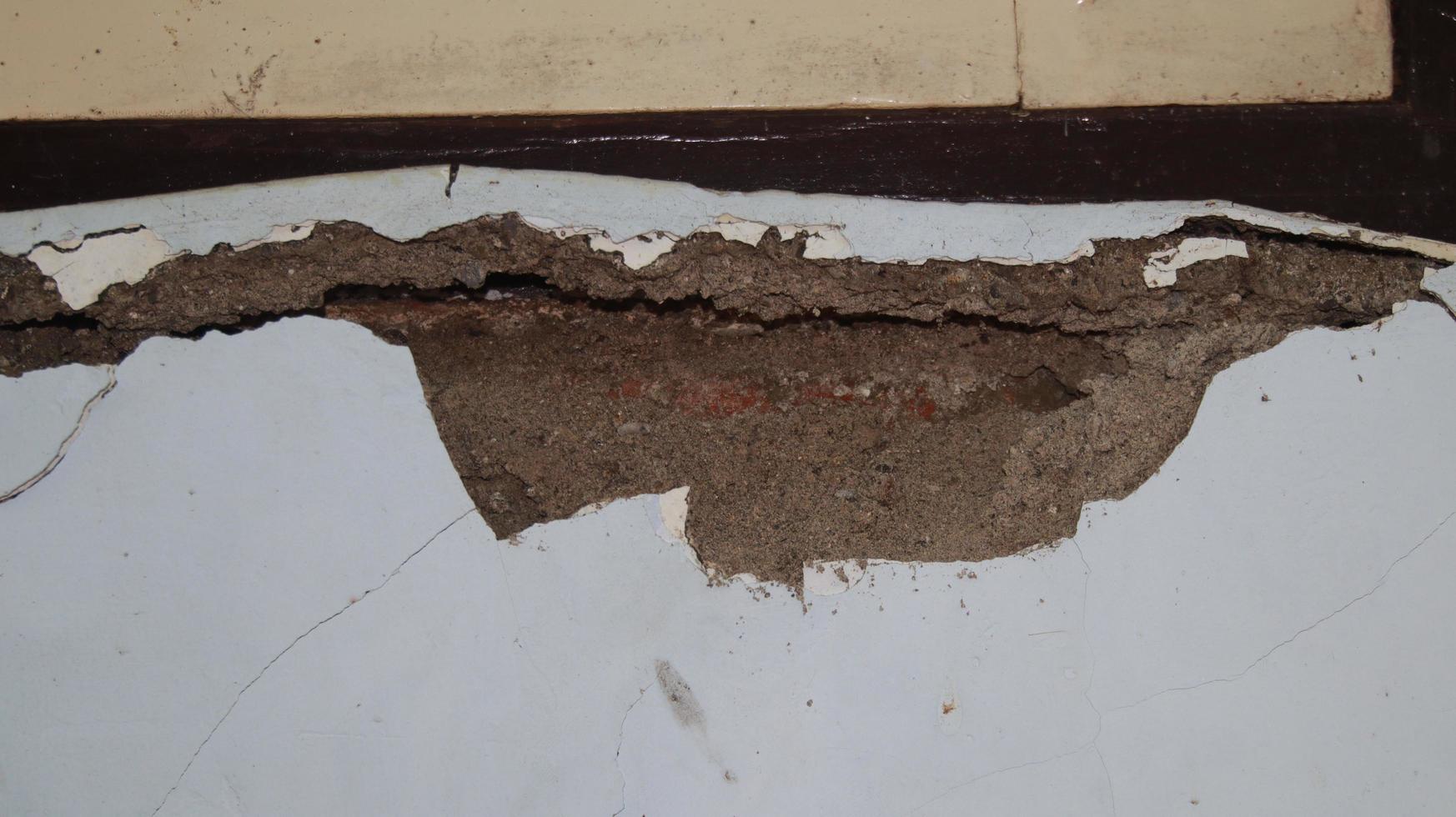 Cement wall collapse. Cracked concrete old wall. dangerous, damaged building structure. photo