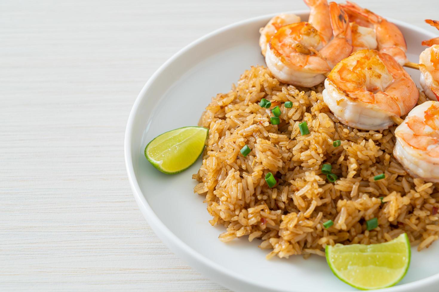 fried rice with shrimps skewers photo