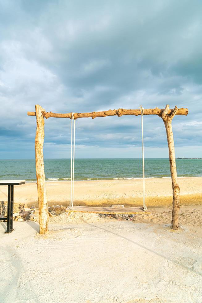 wooden swing on the beach photo