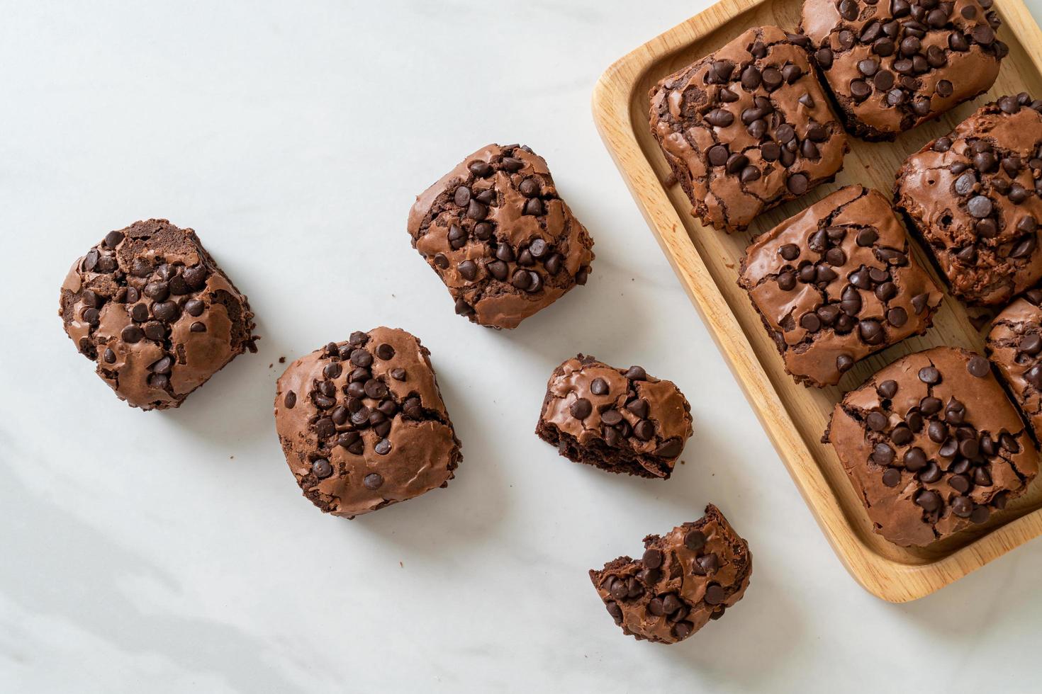 dark chocolate brownies topped by chocolate chips photo