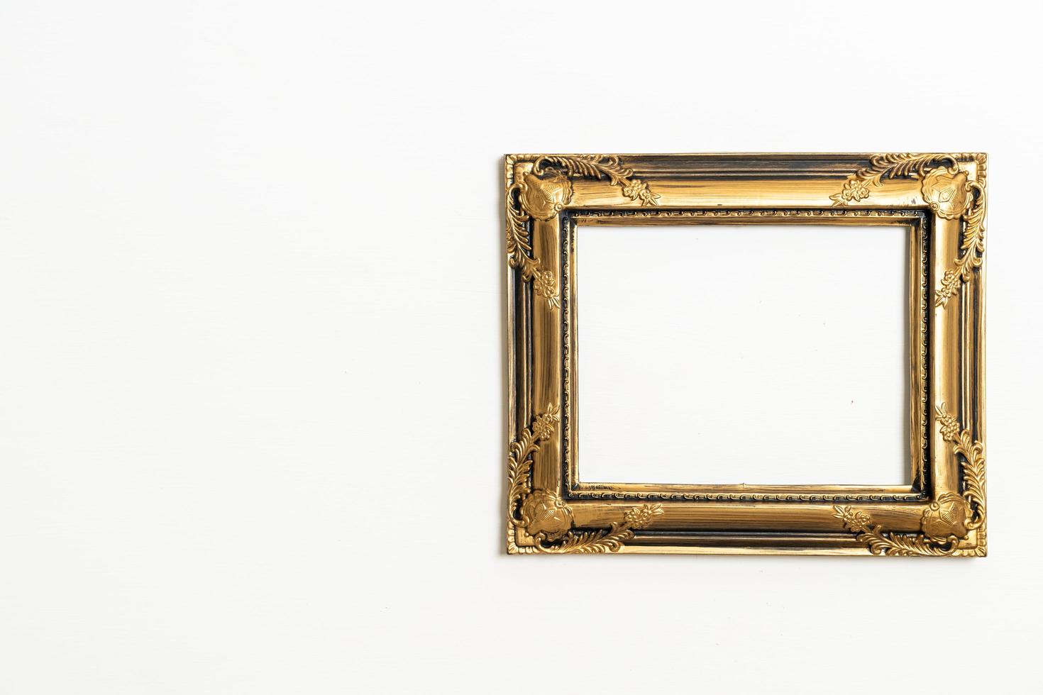 empty picture frame on white wall background photo