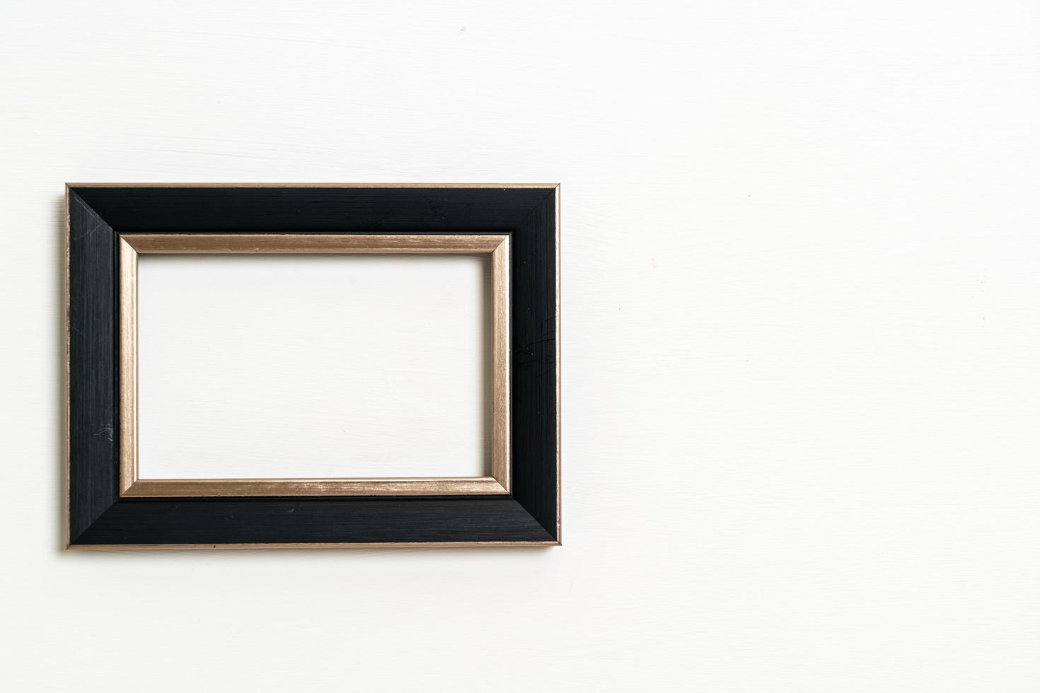 empty picture frame on white wall background photo
