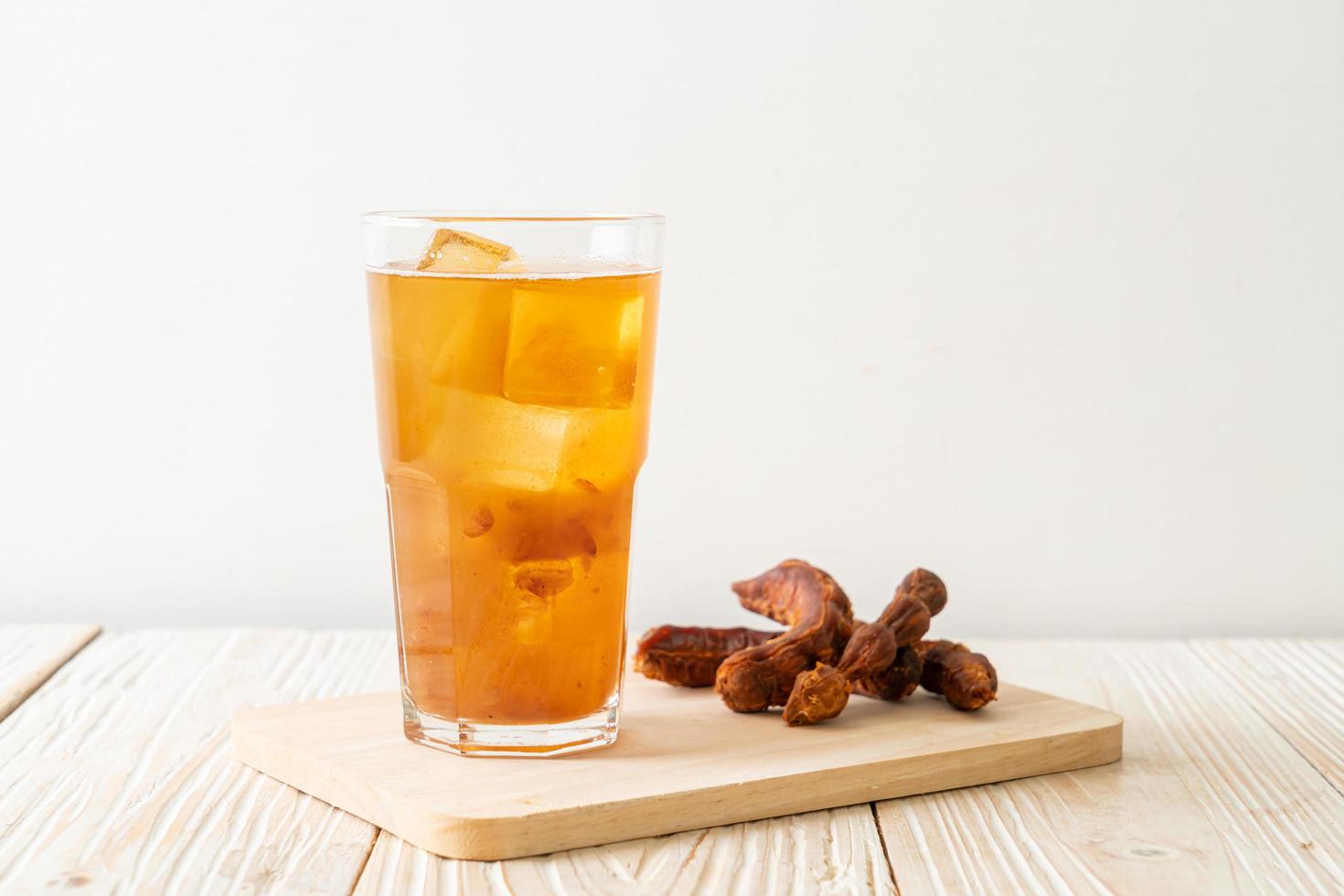 Delicious sweet drink tamarind juice and ice cube photo
