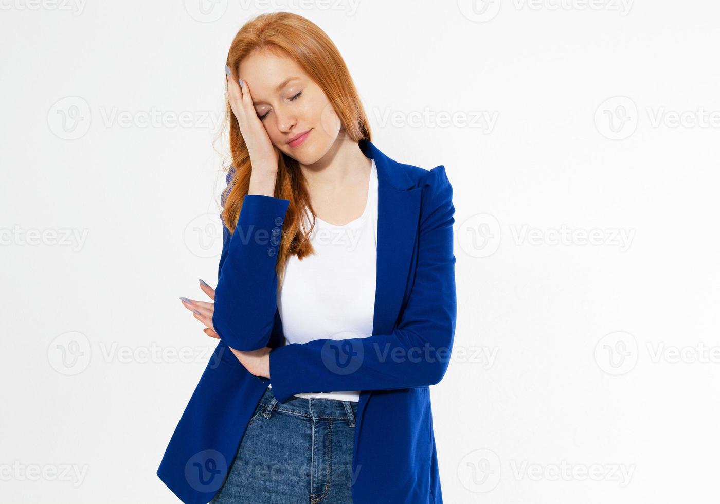 Pretty red hair woman covering her face with hand, Young european girl in dark blue suit hides her face, studio photo isolated on white background. She has social phobia, tying to be anonym