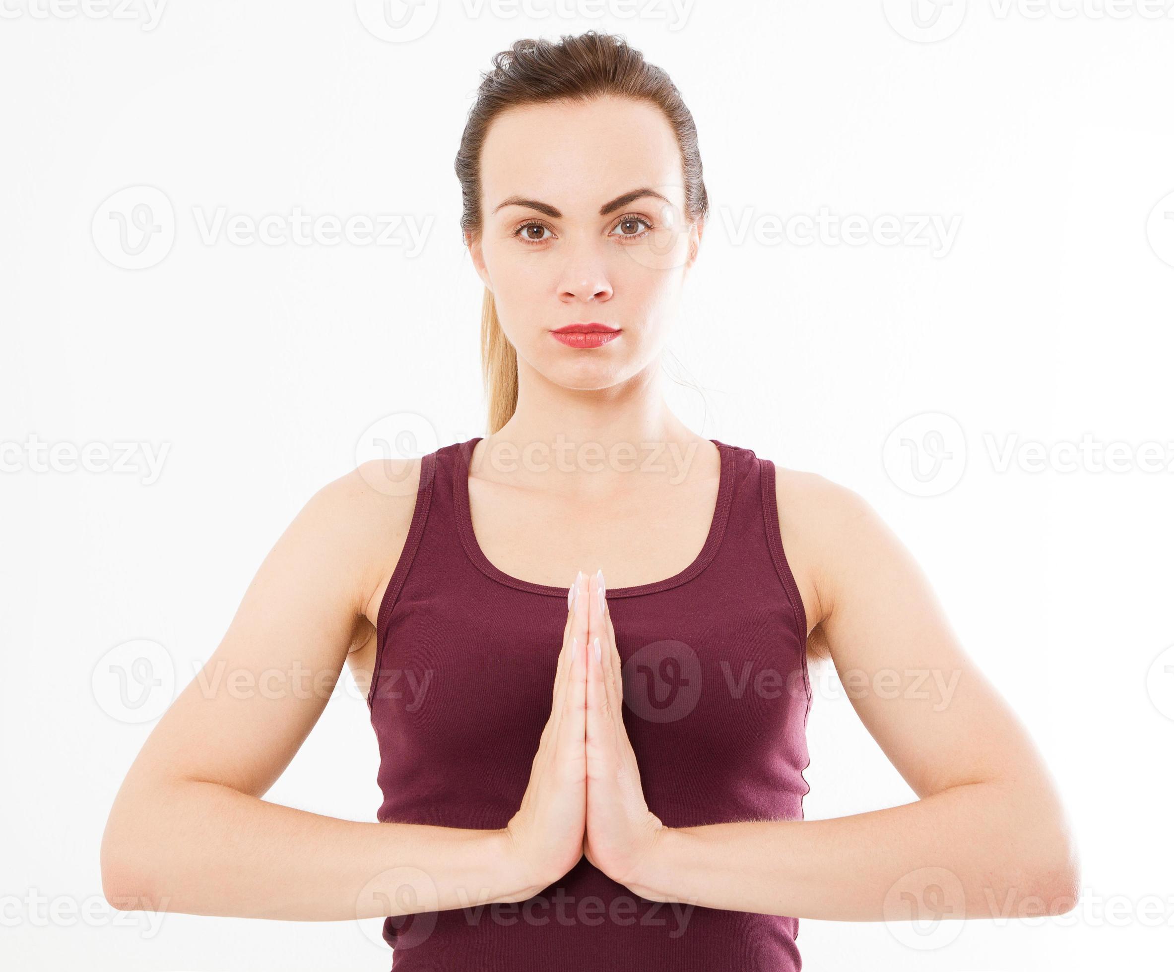 Close-up of hands of beautiful woman, girl in t shirt , meditating indoors, focus on arms in Namaste gesture. Asian medicine, yoga concept. Mock up. Copy space. Template. Blank. photo