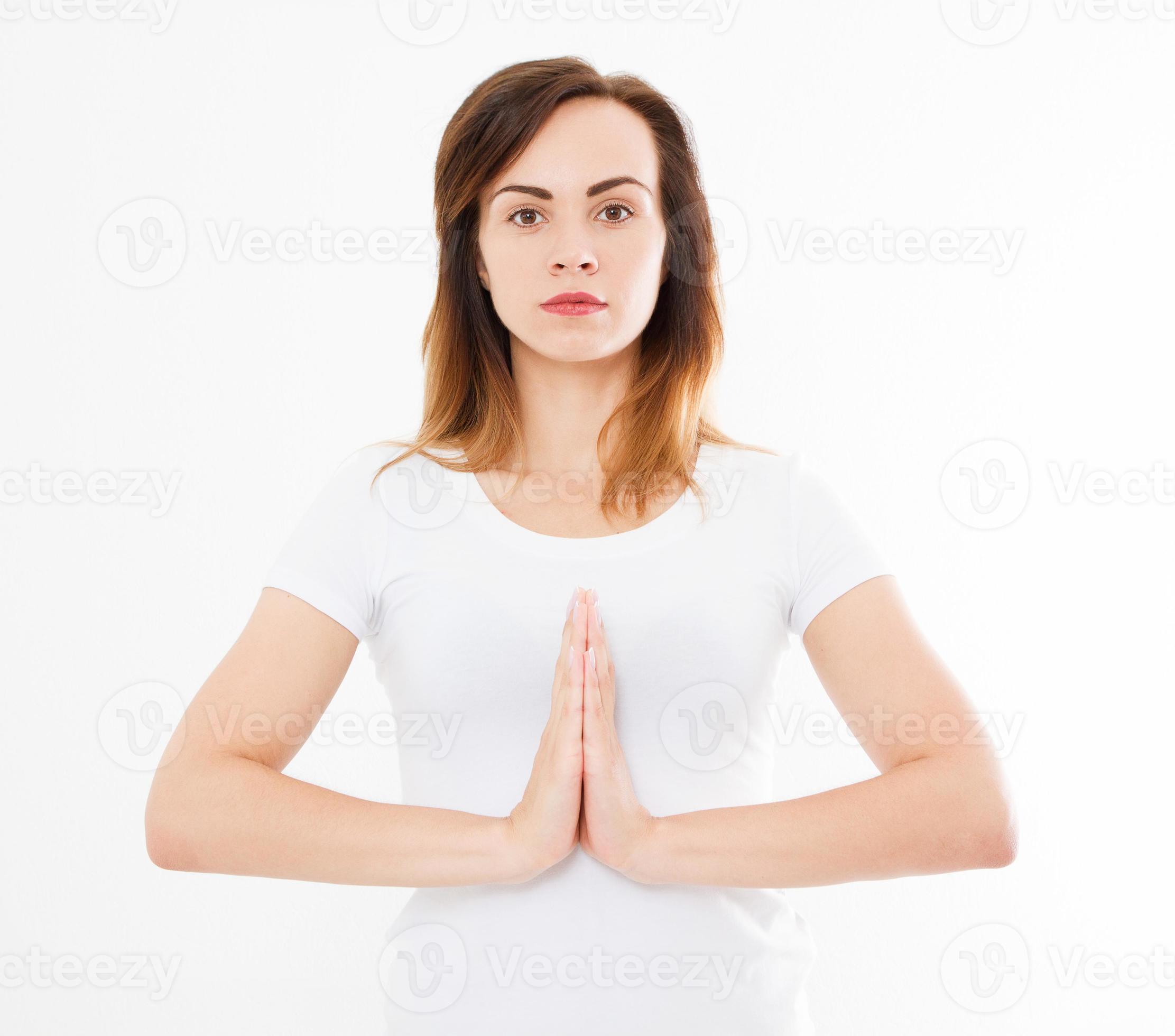 Close-up of hands of beautiful woman, girl in white tshirt , meditating indoors, focus on arms in Namaste gesture. Asian medicine, yoga concept. Mock up. Copy space. Template. Blank. photo