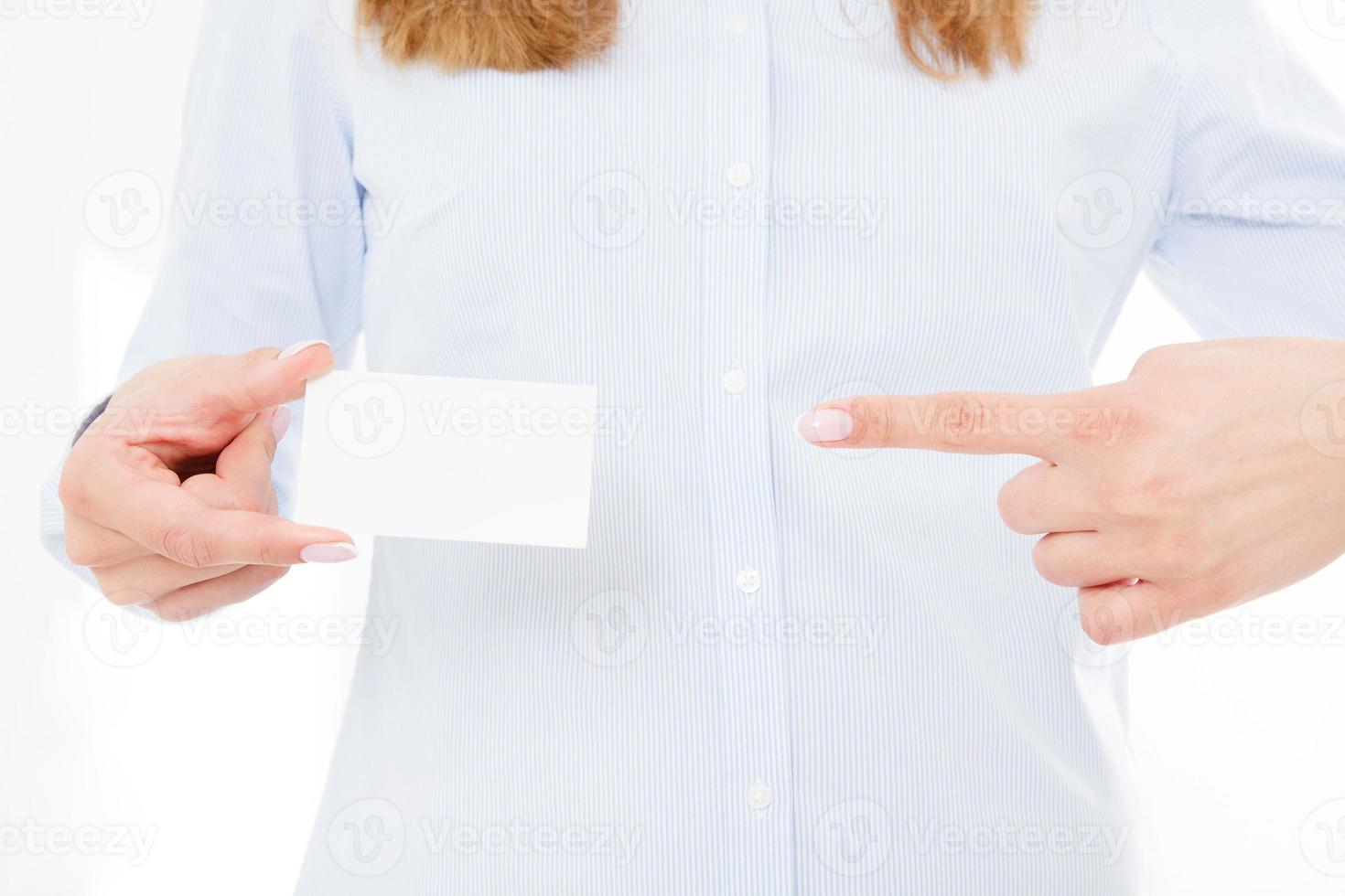 woman holding a blank business card isolated on white background. Copy space photo