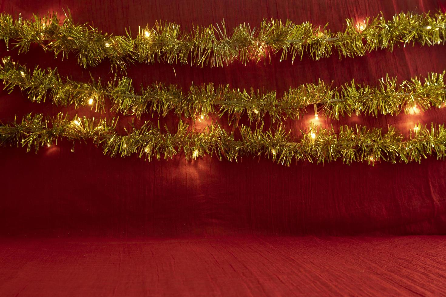 Minimalist concept idea displaying products. christmas and new year background.red, lights, pine flower photo