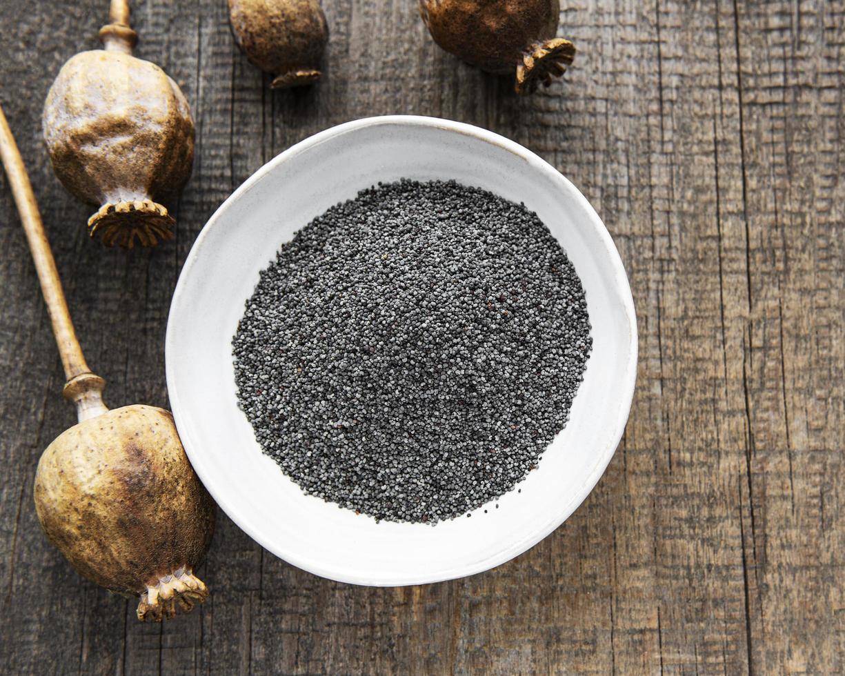 Poppy seeds in small wooden bowl photo