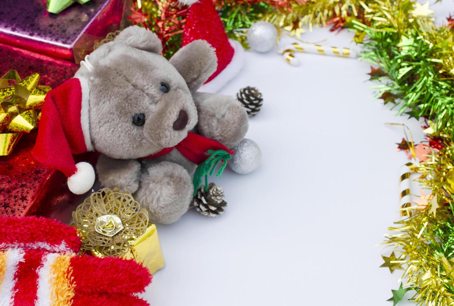 Teddy with christmas decoration on white backgrounds. With space for your text photo