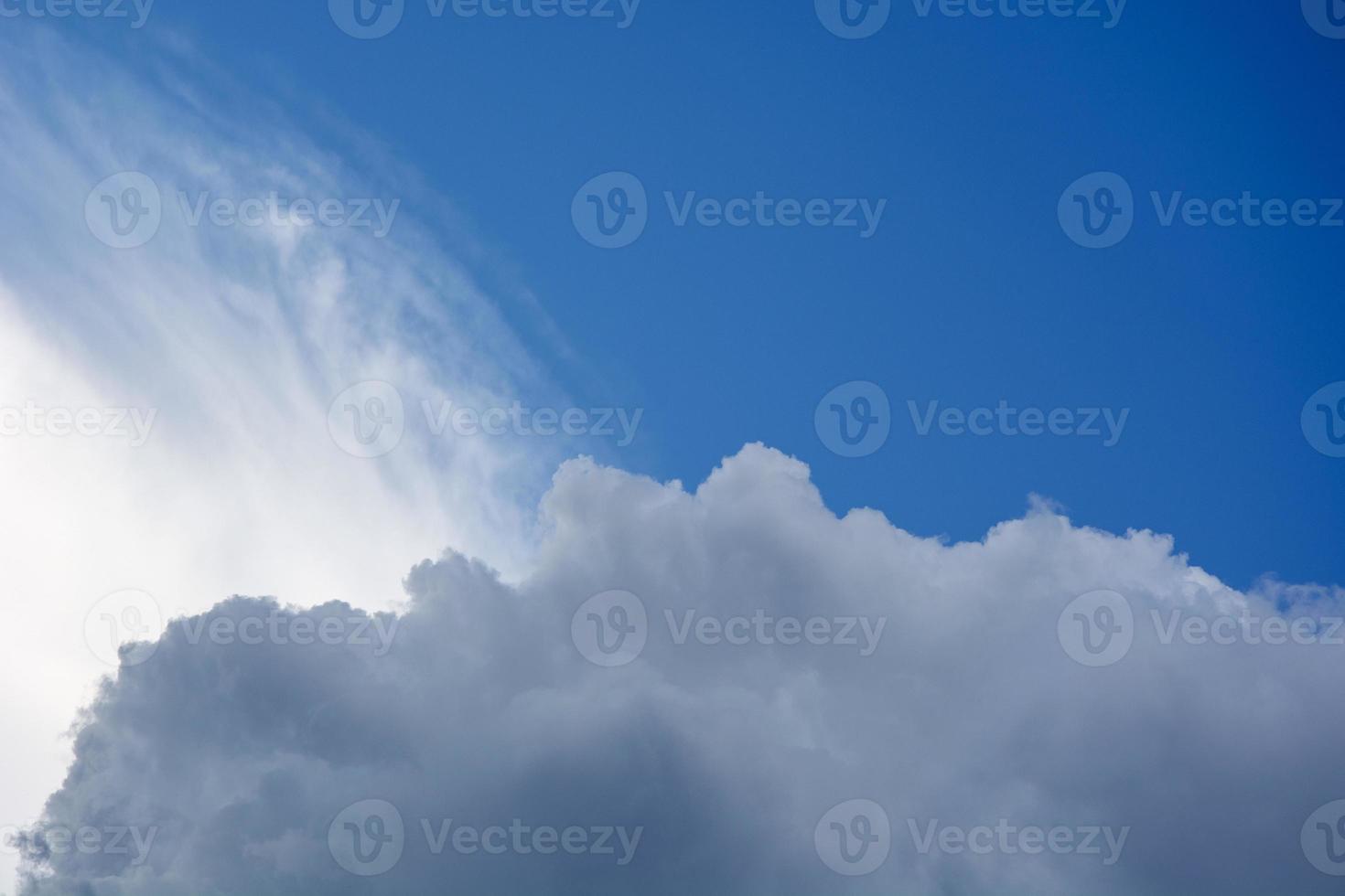 The clouds are cirrus and cumulus. White clouds against the blue sky. photo