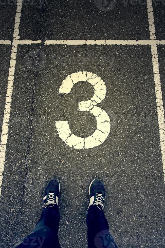 Man's feet on running tracks photo