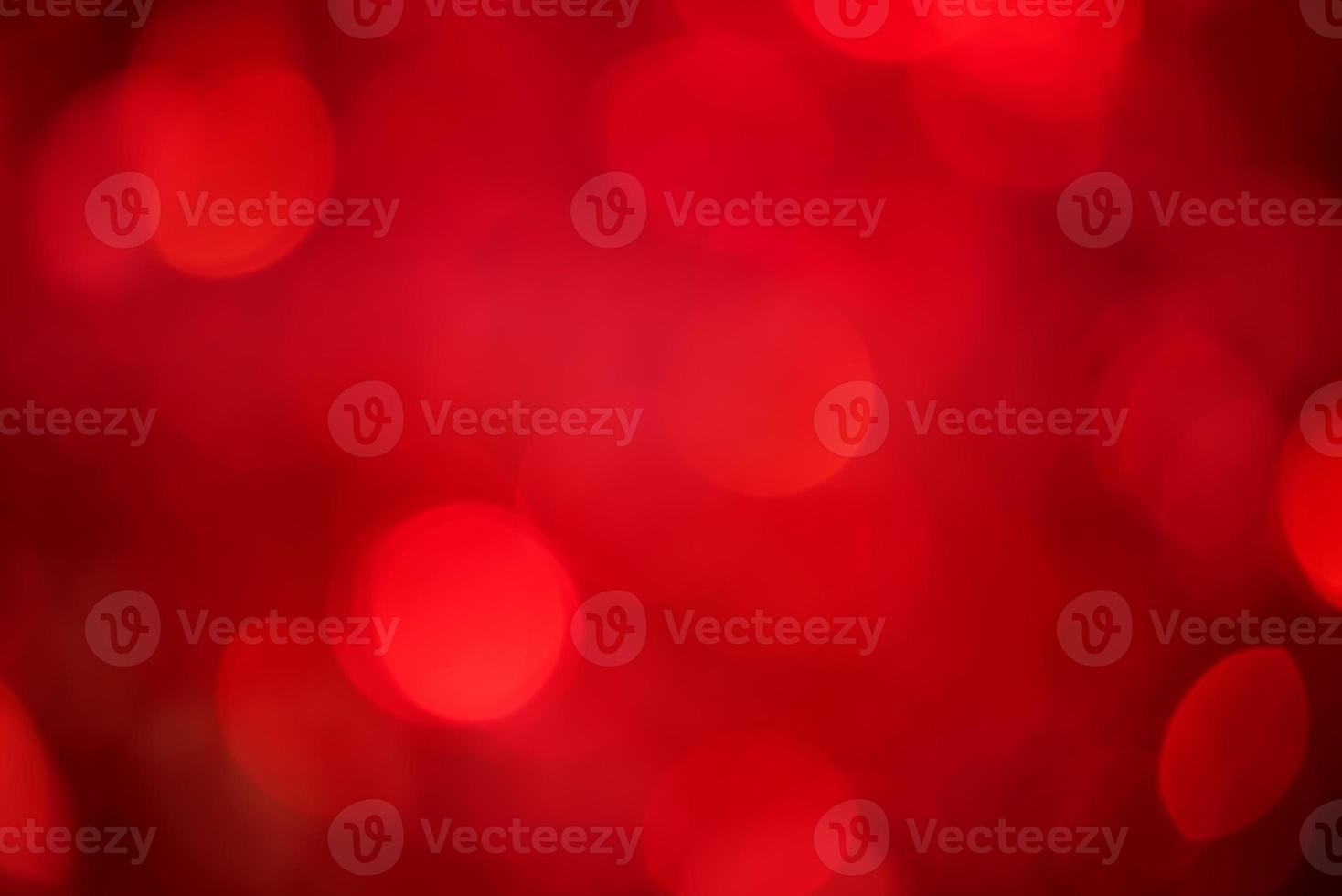 Defocus light on red with black background. The fabric with sequins is out of focus. photo
