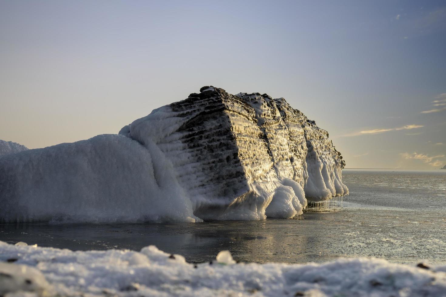 Seascape with a view of a rock in the ice. photo