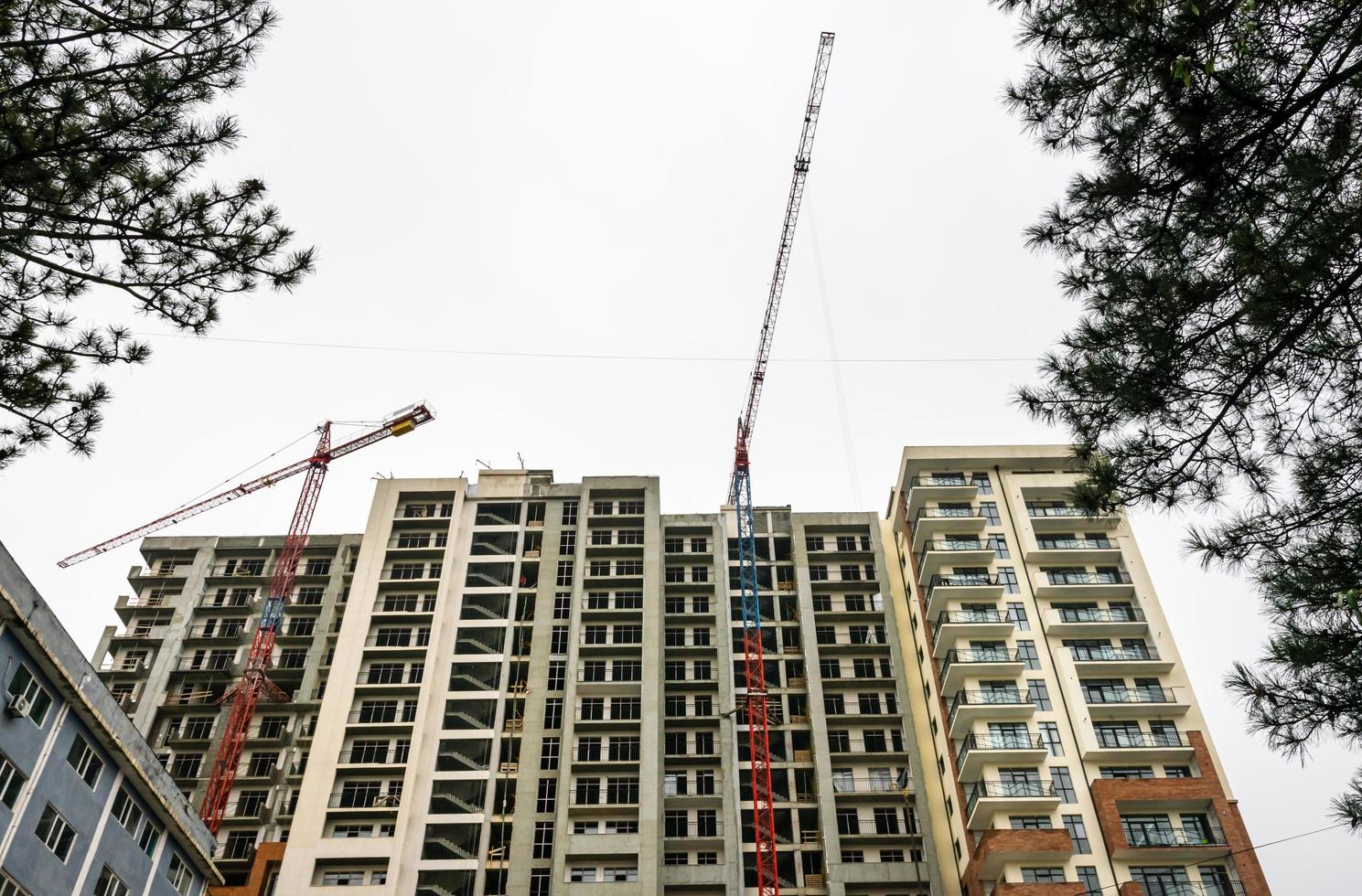 Construction site view up of new house being build with cranes on top photo