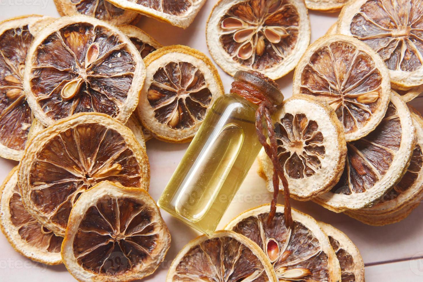 essential citrus oil, dried lemon and spice on table , photo