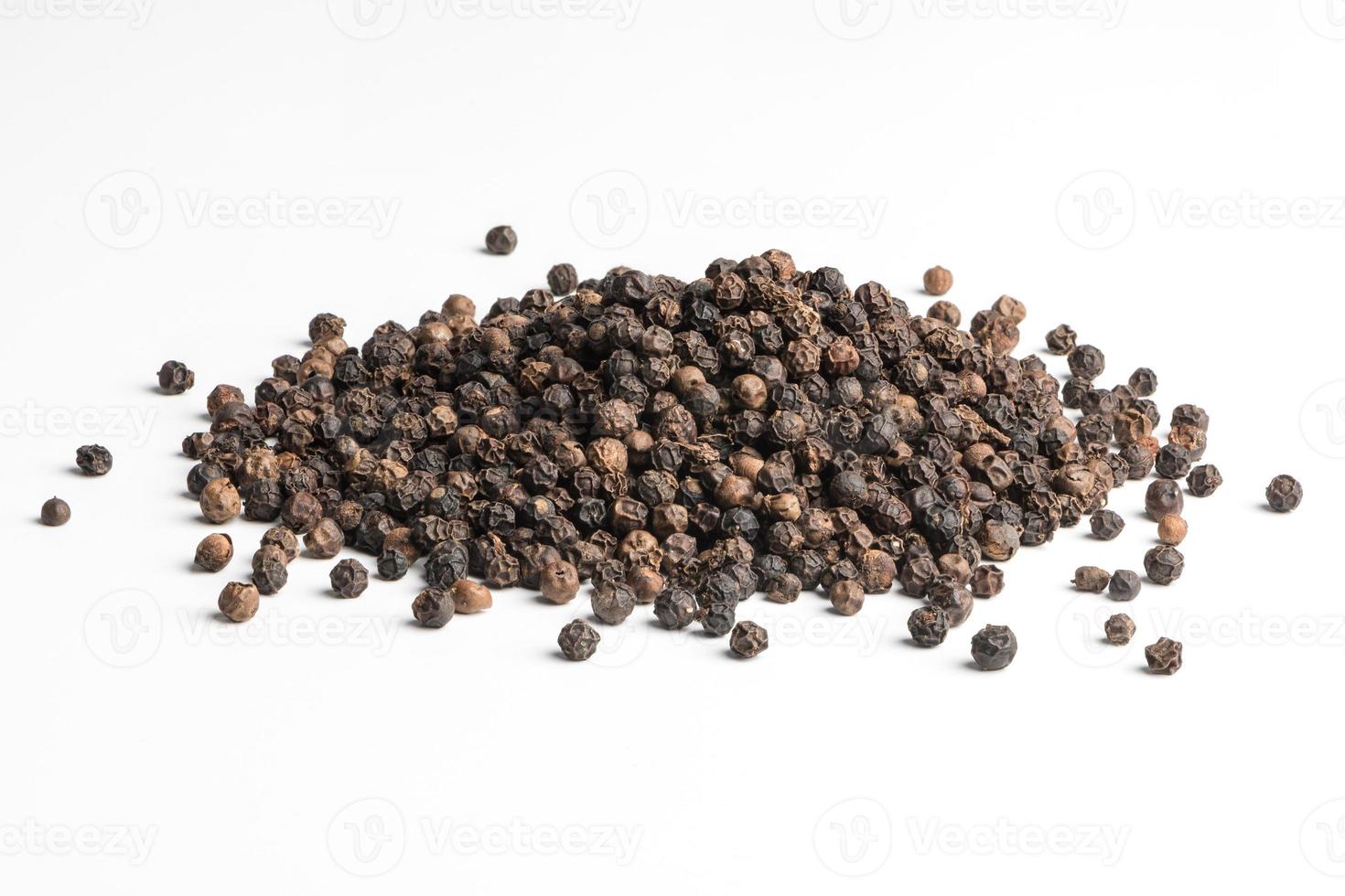 Black pepper seeds on white background photo