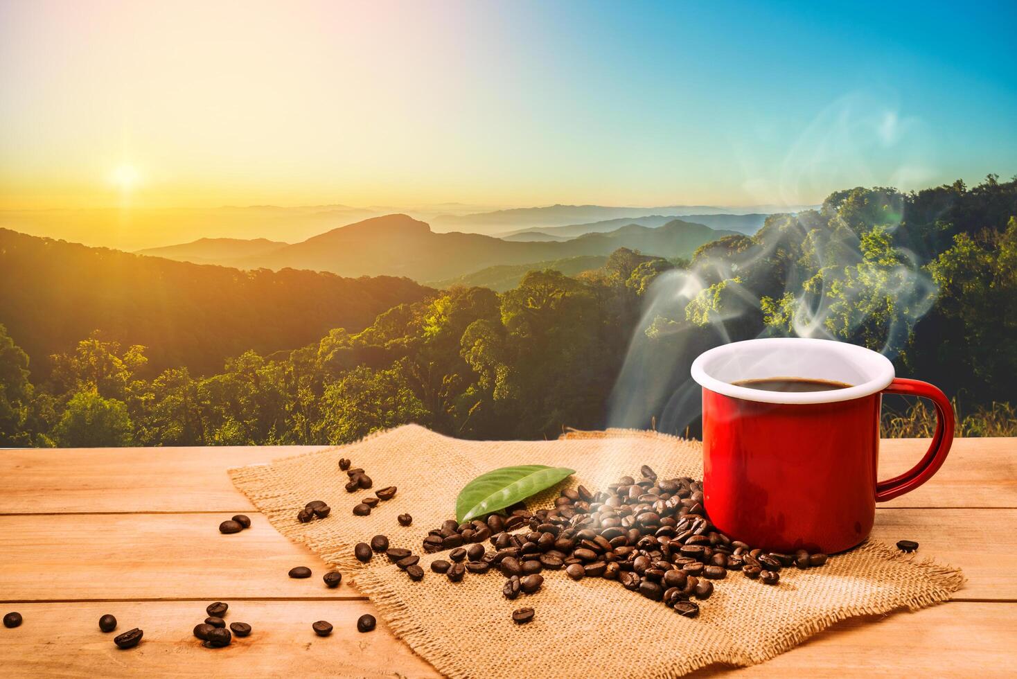 Morning cup of coffee and coffee beans with mountain background at sunrise. Beauty mountain landscapes photo