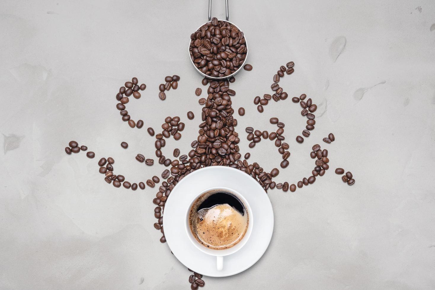 Cup of coffee black with coffee beans on a white background with copy space for your text photo