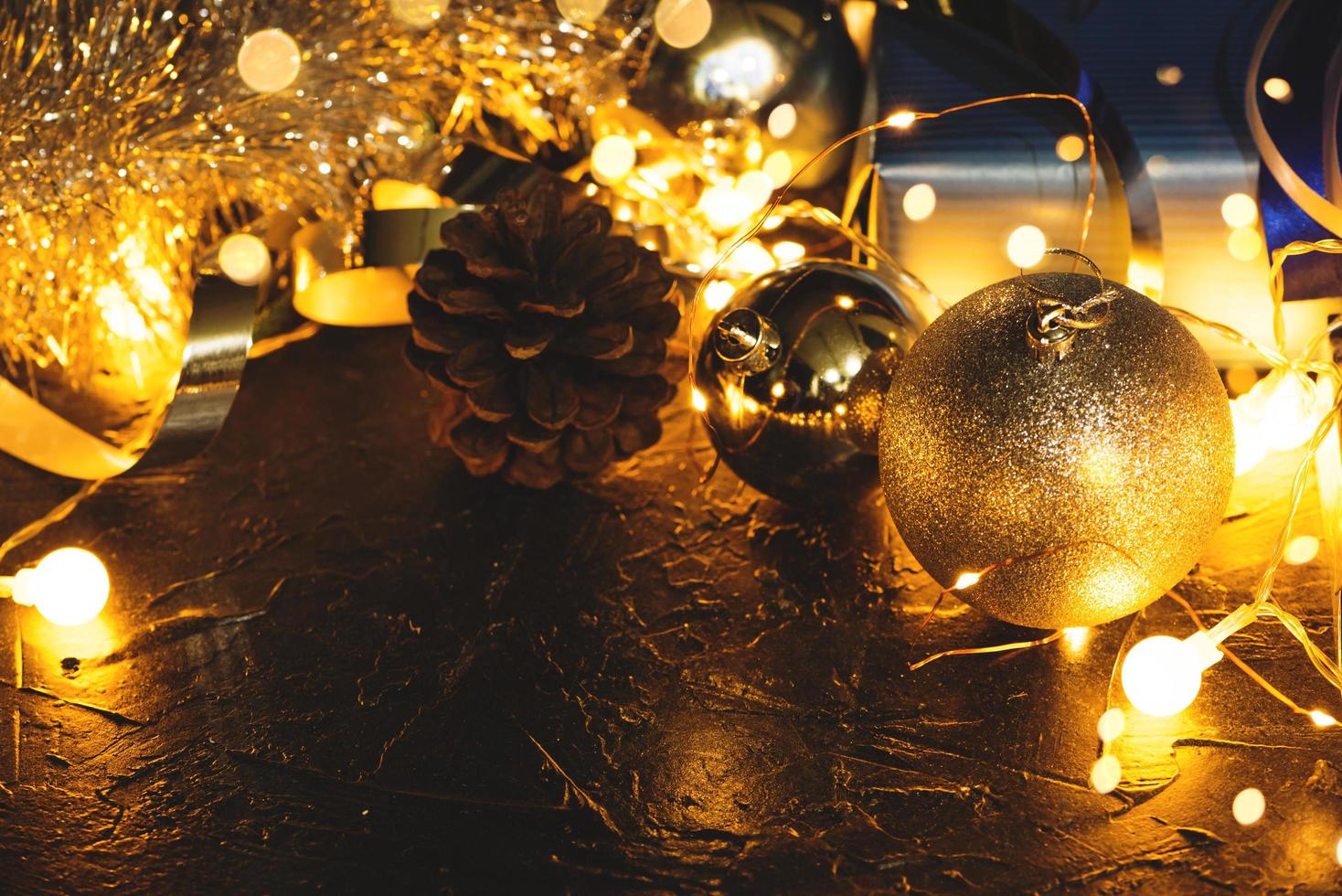 Christmas decoration balls on abstract bokeh black background with copy space and decorative LED lights. Merry Christmas and New Year. photo