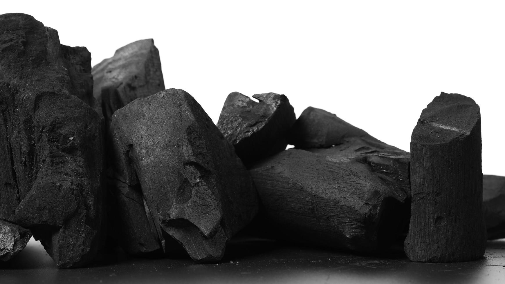 Wood charcoal. Black Charcoal on black textured floor. Used for cooking photo