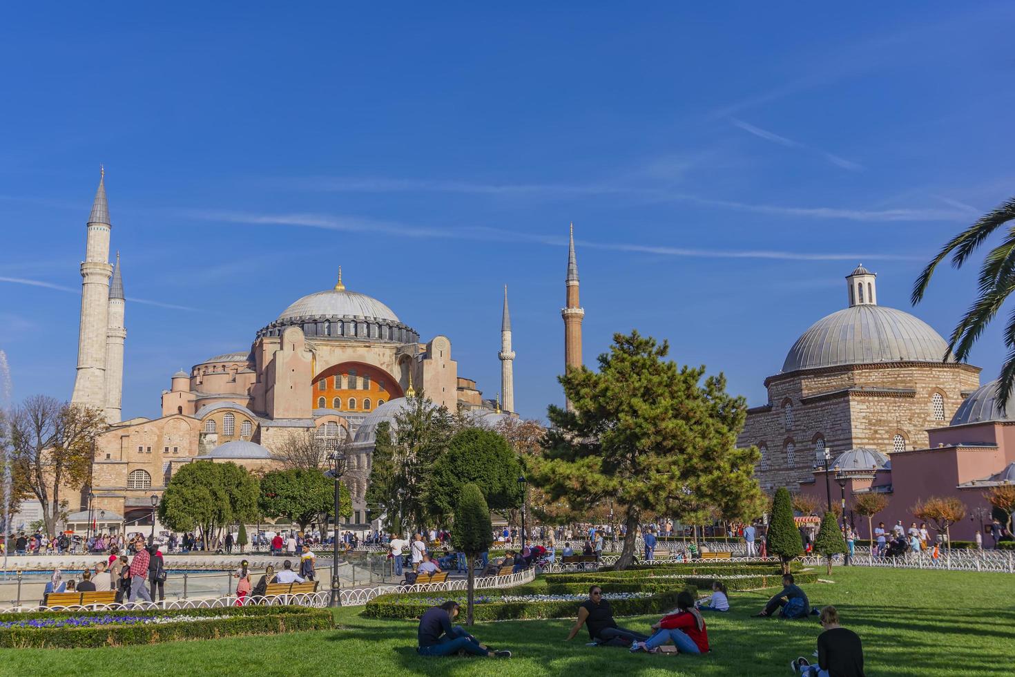 ISTANBUL, TURKEY, NOVEMBER 10, 2019 - Unidentified people by Hagia Sophia in Istanbul, Turkey. It is the former Greek Orthodox Christian patriarchal cathedral and later Ottoman imperial mosque photo