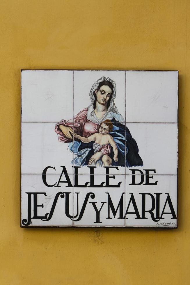 MADRID, SPAIN, MARCH 13, 2016 - Closeup of the street sign. Street signs in Madrid are hand-painted ceramic tiles typically composed within 9 or 12 tiles. They depict the name of the alley or street. photo