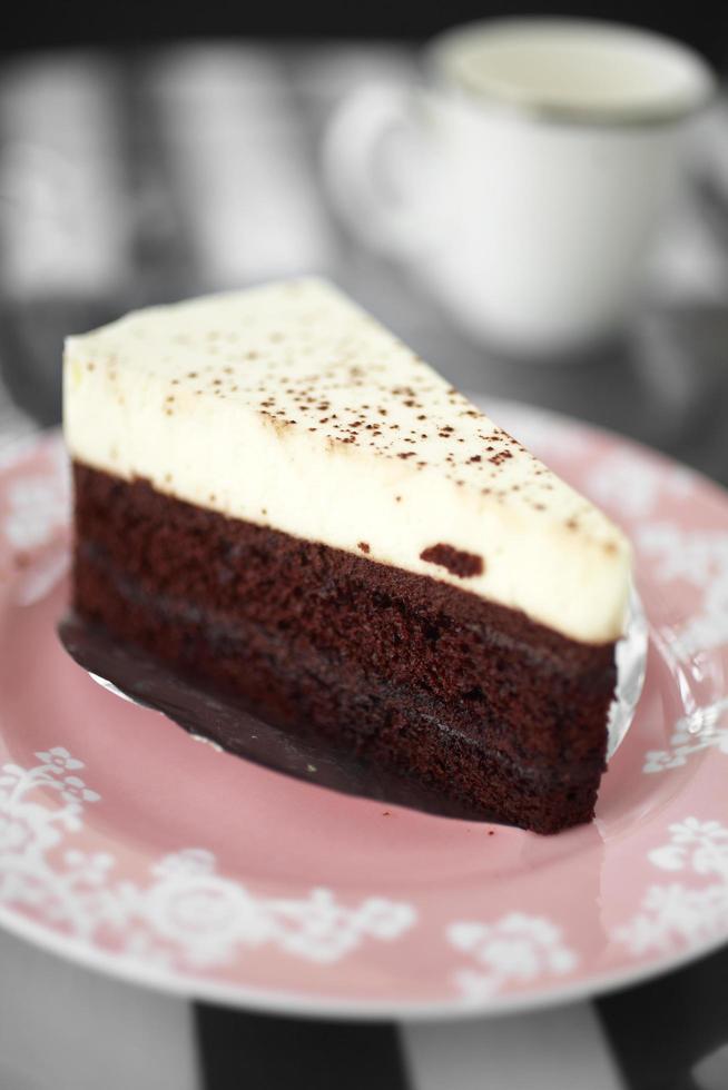 Chocolate cake on ceramic dish in cafe photo