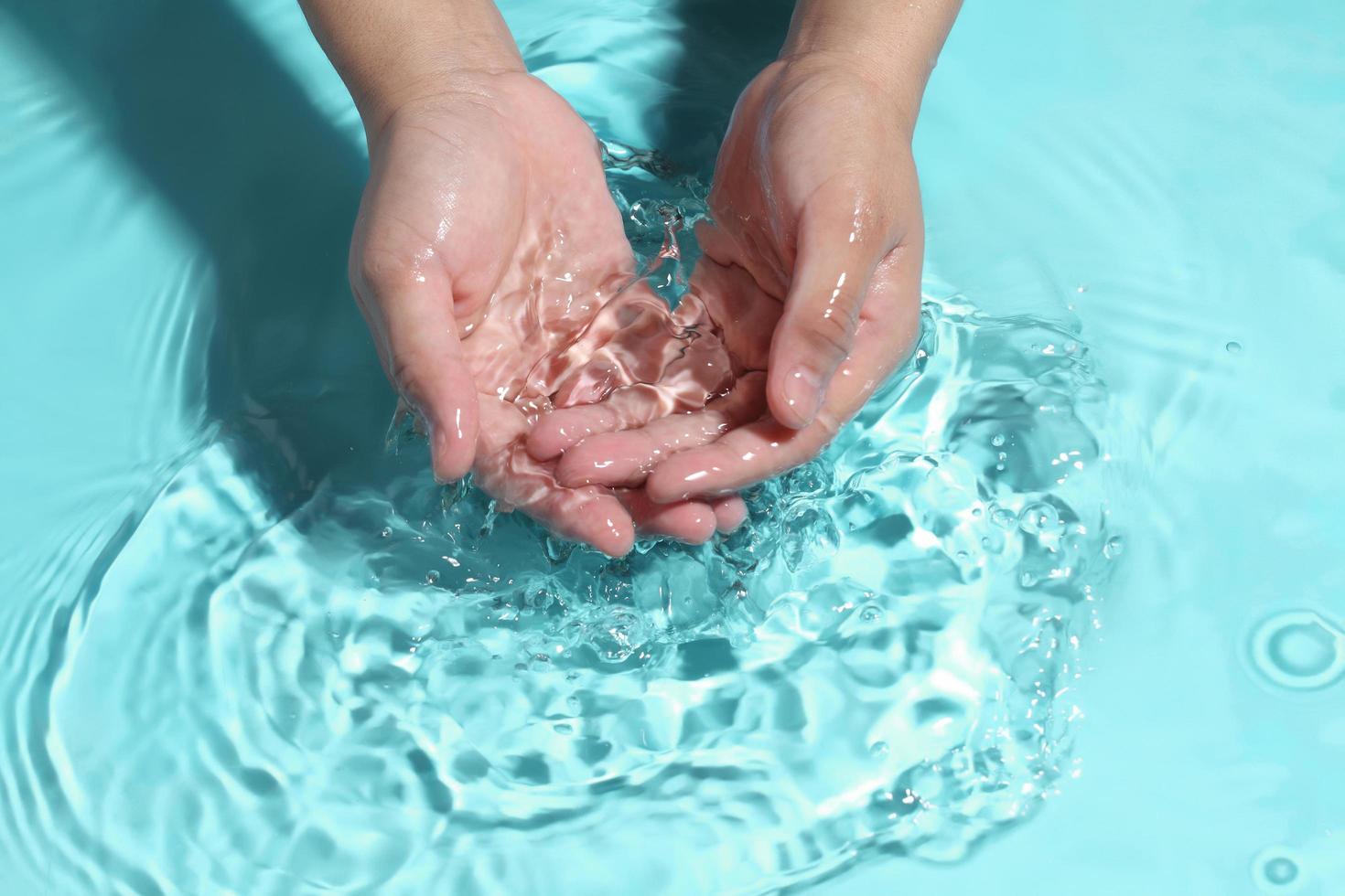 Woman washing hands in water to clear respiratory bacteria and viruses. photo