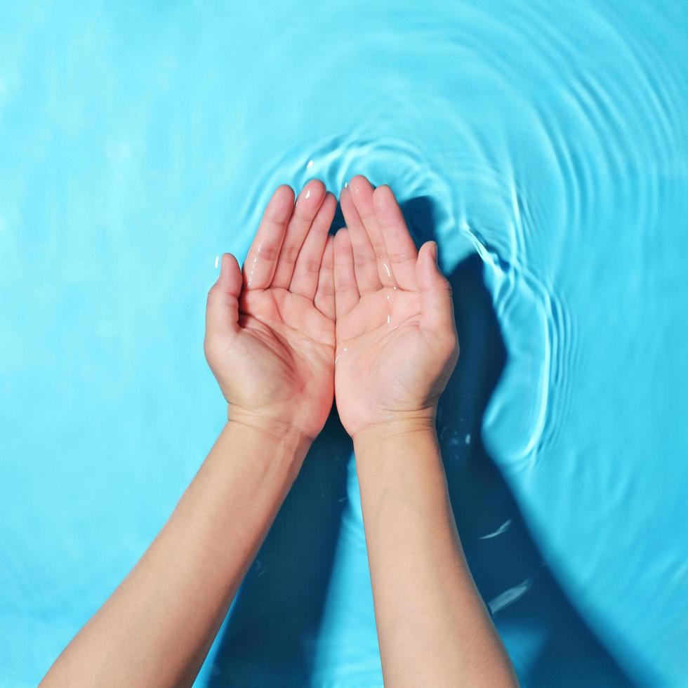 Woman washing hands in water to clear respiratory bacteria and viruses. photo