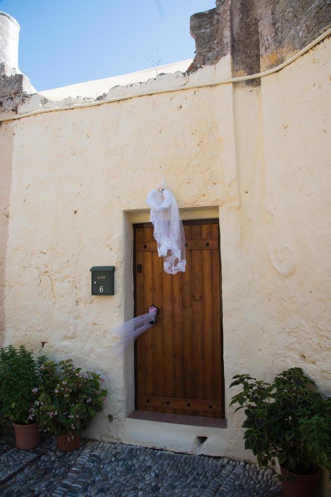 Bridal veil on a door as a signal that a woman living at that house celebrates her marriage that day. Rhodes old town, Greece photo