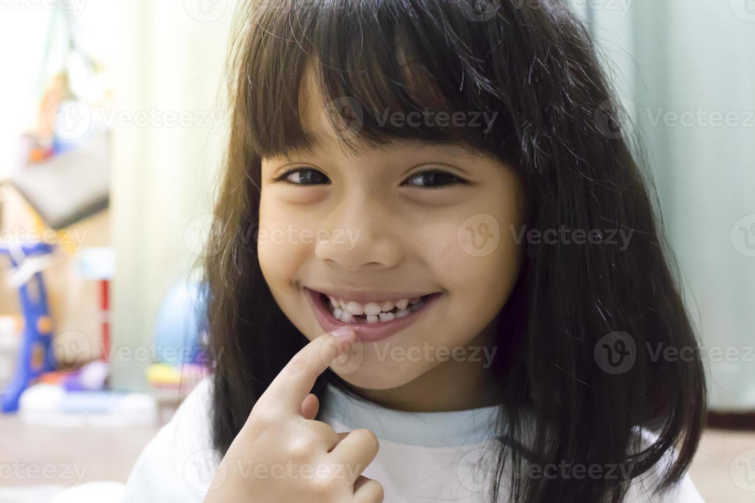 little girl smile losing his first tooth photo