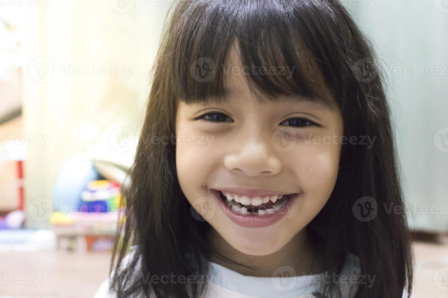 little girl smile losing his first tooth photo