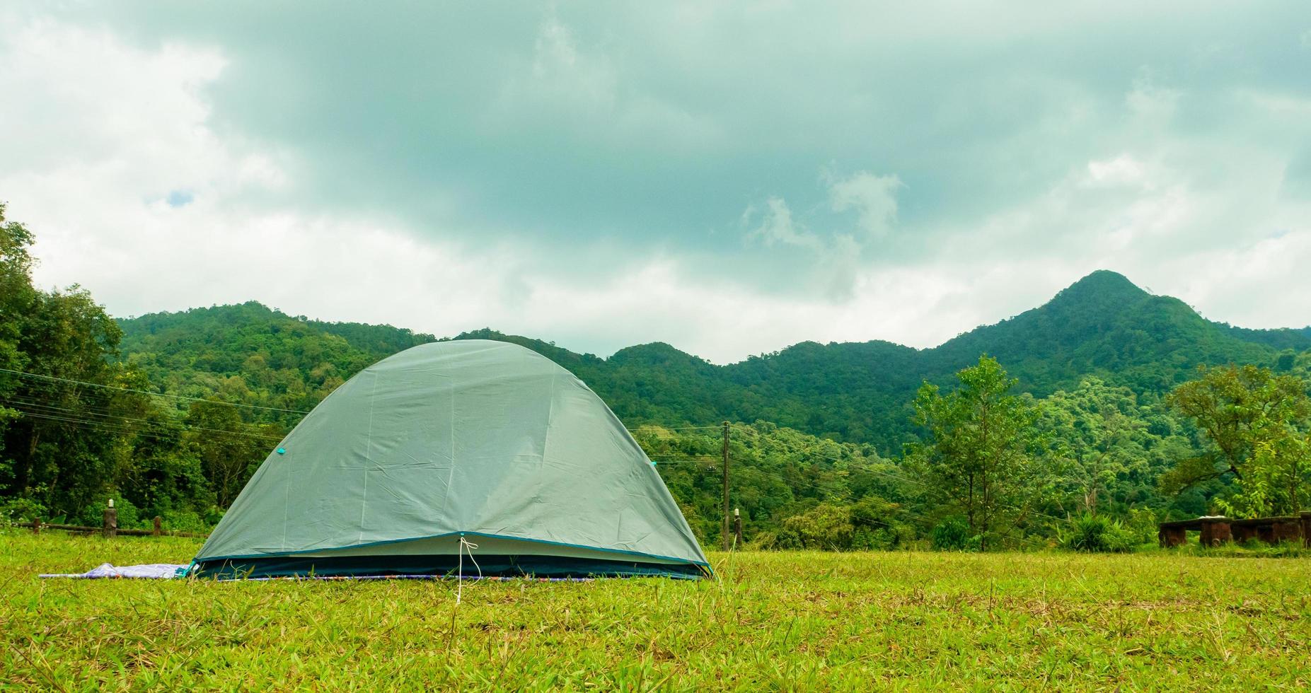 Light tent to watch the mist and the sun rise in a forest camp among the meadows. photo