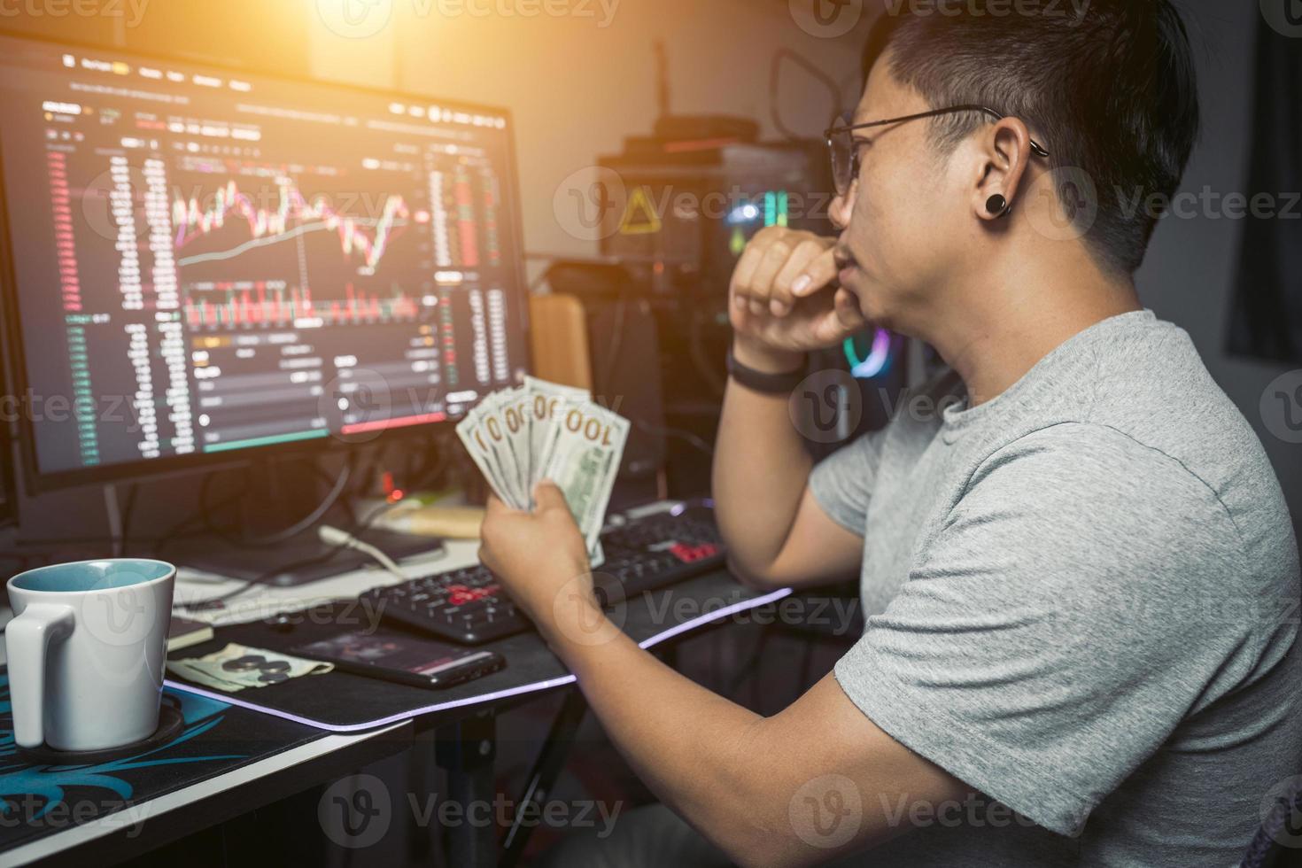 work from home lifestyle of young trader holding USD dollar trading money exchange  with crypto blockchain online photo
