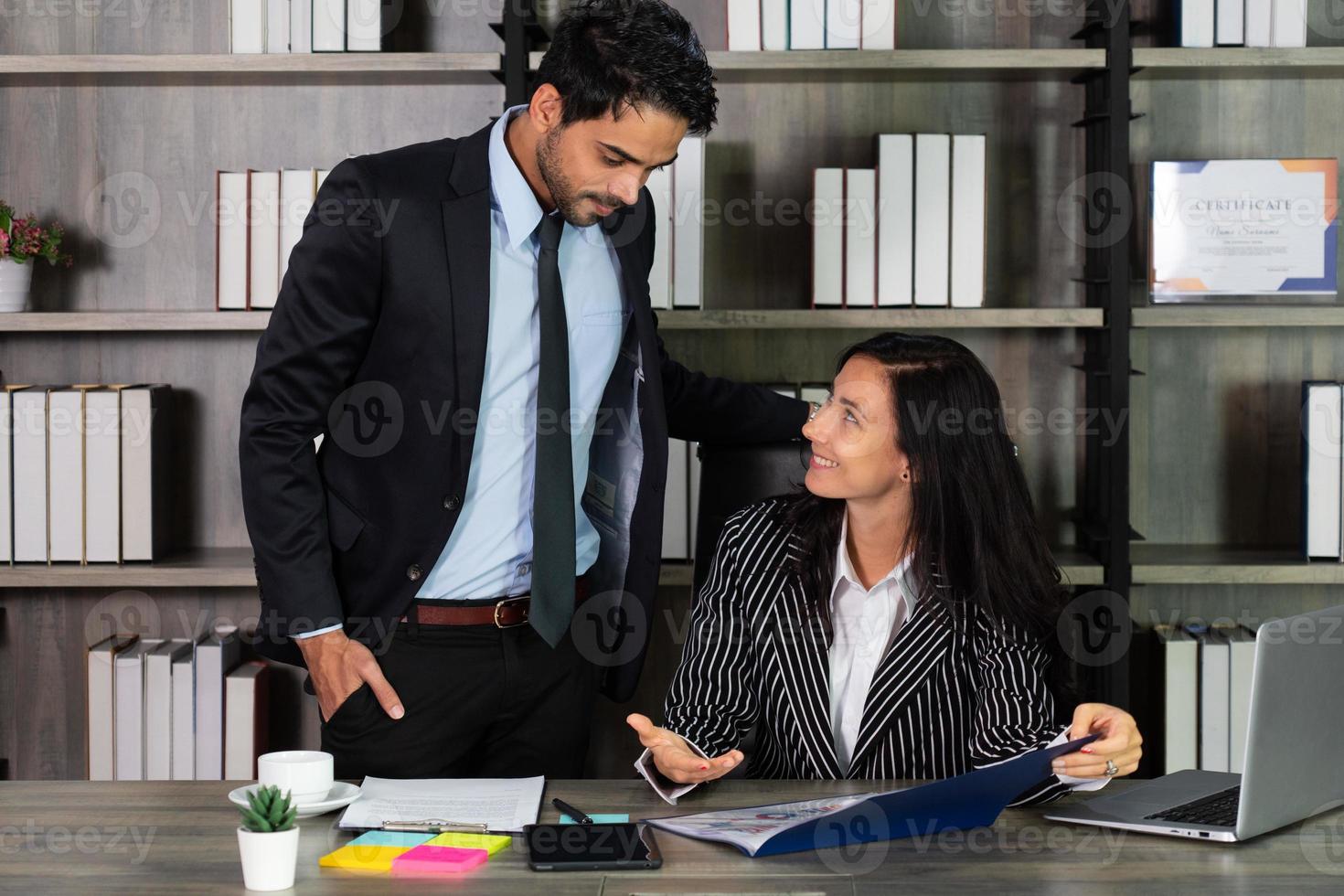 young caucasian businesswoman talking with middle east businessman in office. business concept photo