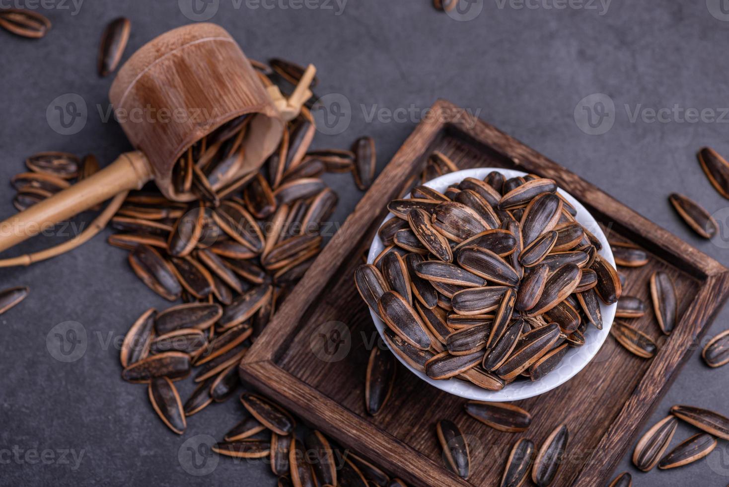 Sunflower seeds in the dark background inside the container photo