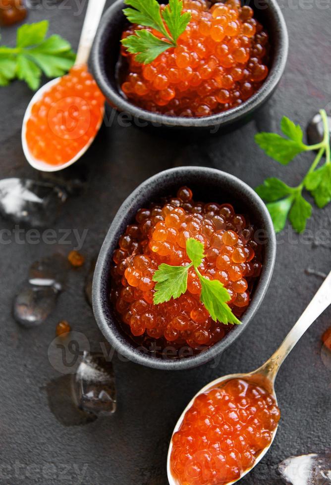 Red caviar on a black background photo