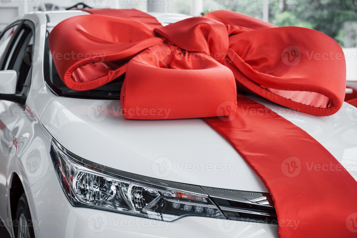 A beautiful new white car awaits its buyer in the cabin. photo