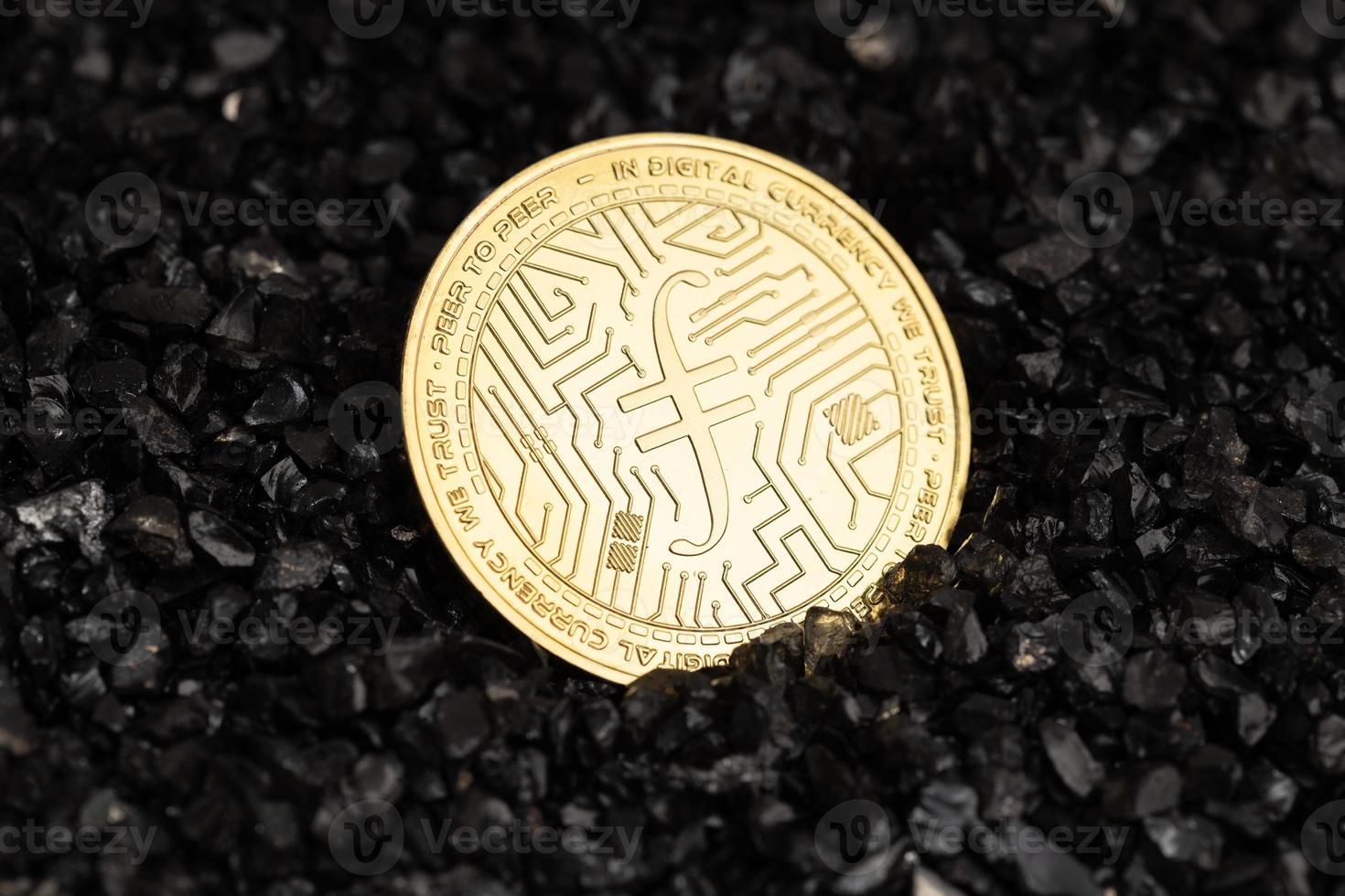 Filecoin coin on black gravel background. Cryptocurrency blockchain money photo