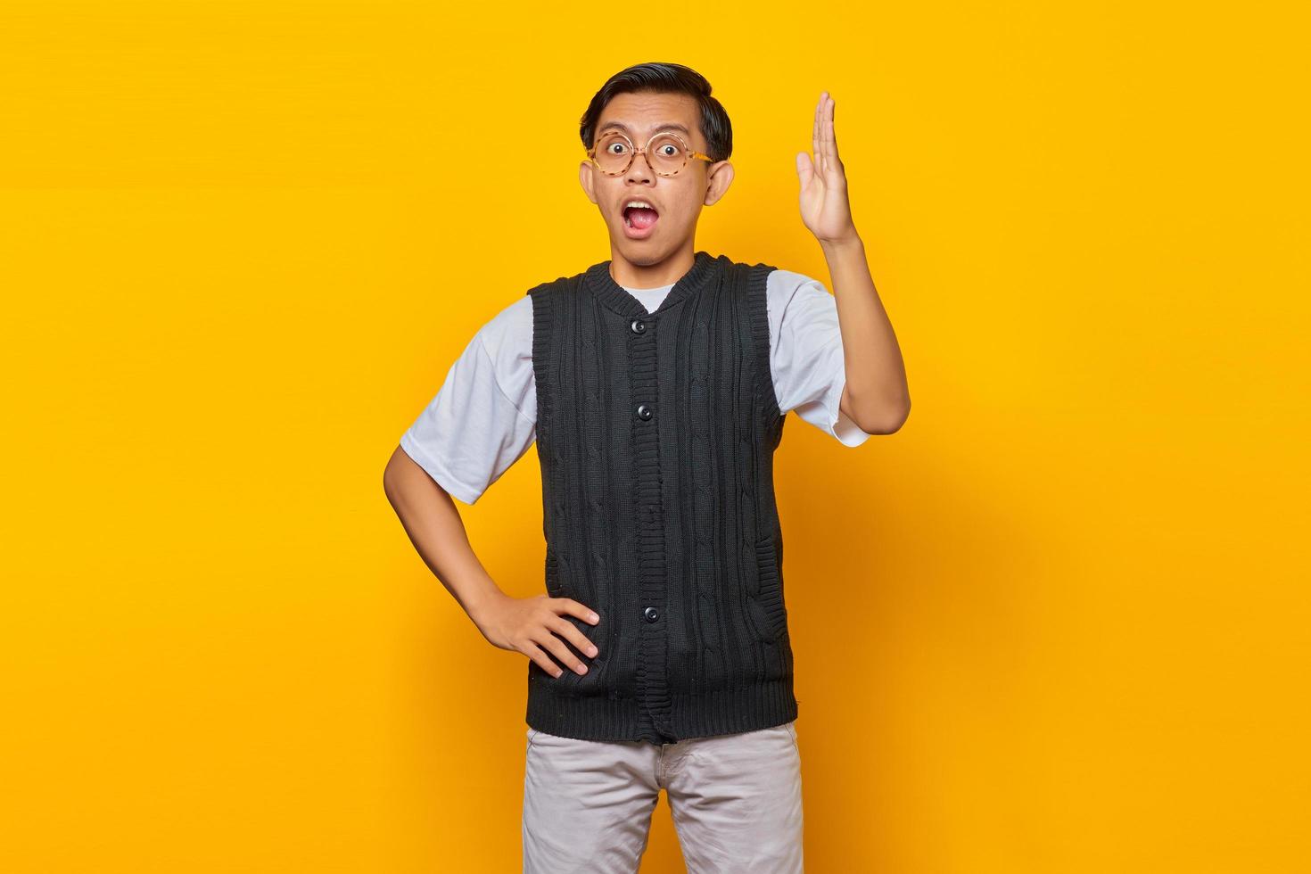 Portrait of unhappy young Asian man having displeased expression and stretching his arms expressing uncertainty photo