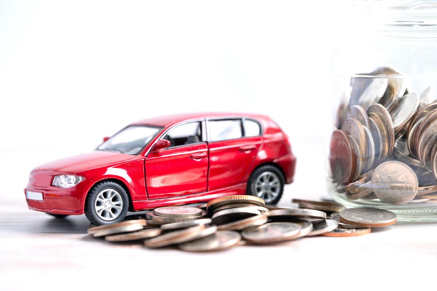 Car on coins background Car loan, Finance, saving money, insurance and leasing time concepts. photo