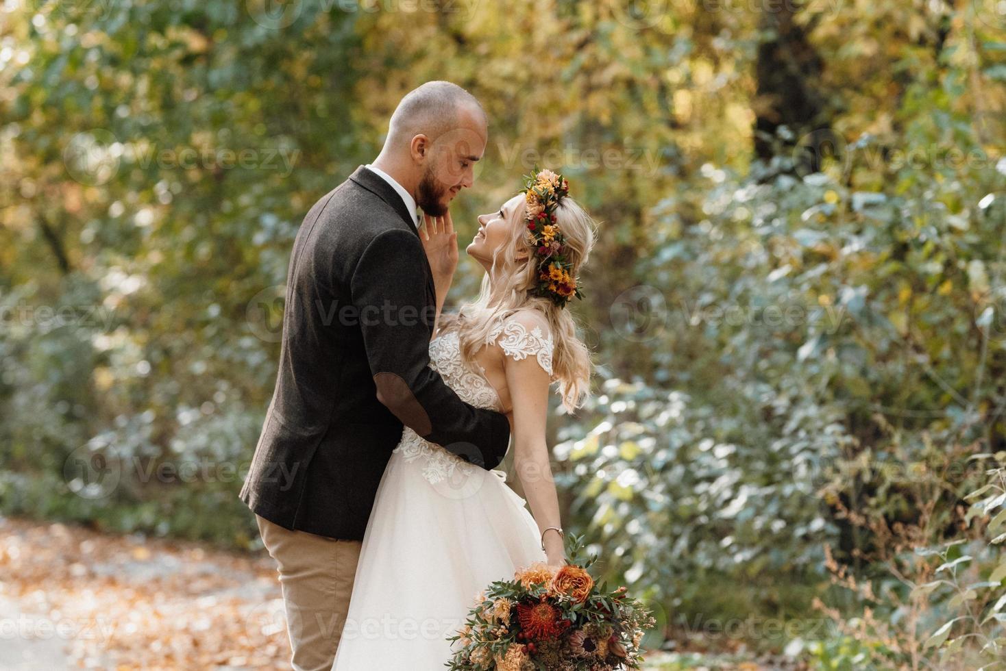 paseo de la novia y el novio por el bosque de otoño foto